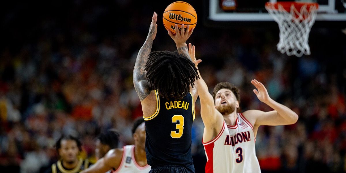 Michigan's Elliot Cadeau shoots over an Arizona defender, April 2026